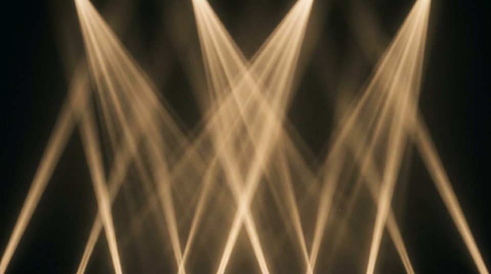 Golden volumetric light beams crossing through haze